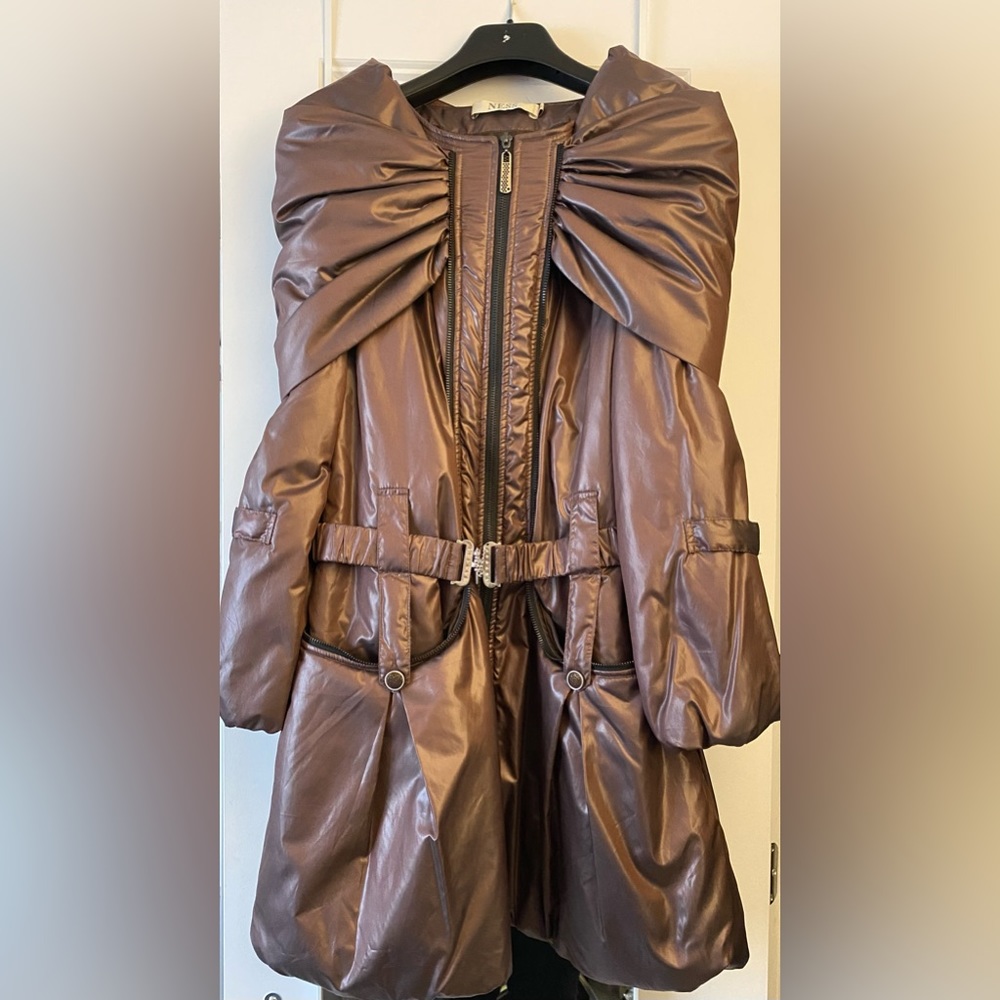 A stylish puffer like coat with a hood that can drop over shoulders.